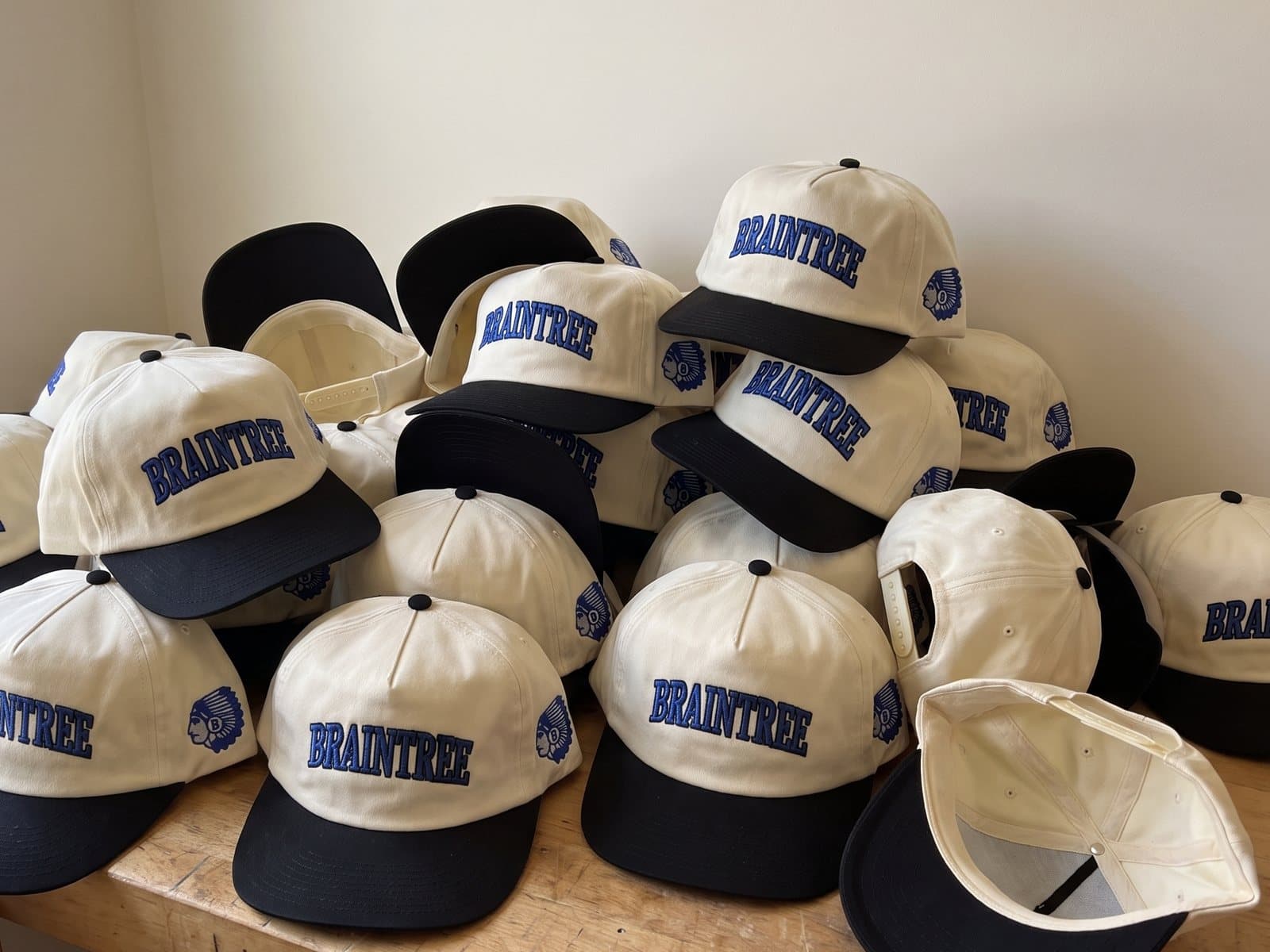 A bulk order of Townies hats piled on the workbench